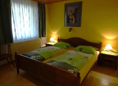 a bedroom with two beds with green pillows at Apartments Zorč in Bohinj