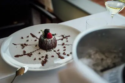 a chocolate dessert on a plate on a table at Bužinel Estate in Dobrovo
