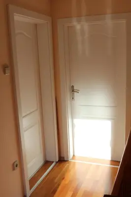an empty room with a door and a window at Apartma Lipa in Mojstrana