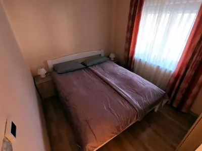 a small bed in a small room with a window at Apartma Lipa in Mojstrana