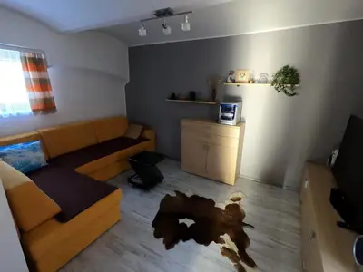 a living room with a couch and a table at Apartma Lipa in Mojstrana
