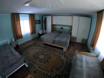 a small bedroom with a bed and a couch at Apartma Lipa in Mojstrana