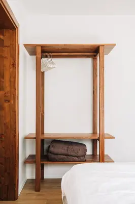 a bedroom with a bed and wooden shelves at Apartment House Blazar in Tolmin