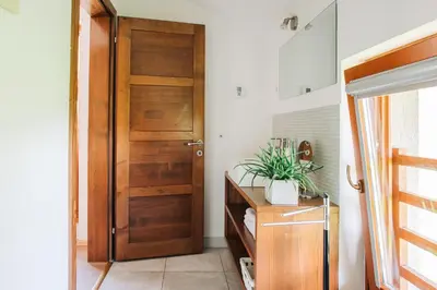 a bathroom with a wooden door in a room at Apartment House Blazar in Tolmin