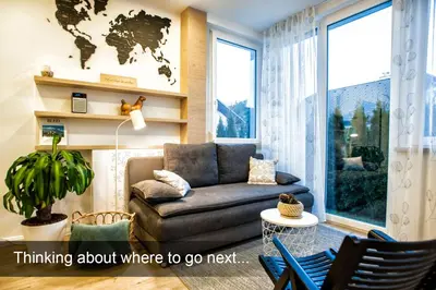 a living room with a couch and a map on the wall at 4* Green Heaven in centre of Bled in Bled