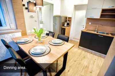 a dining area with a wooden table in a kitchen at 4* Green Heaven in centre of Bled in Bled