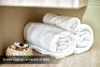 a pile of towels in a box with a basket at 4* Green Heaven in centre of Bled in Bled