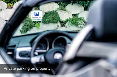 a car dashboard with a parking sign in front of a stone wall at 4* Green Heaven in centre of Bled in Bled