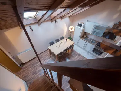 an overhead view of a room with a table and a kitchen at Vila Bovec Sky mansard apartment in Bovec