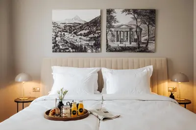 a bed with a tray of food on it at Hotel Slatina Superior in Rogaška Slatina