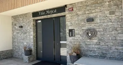 a door to a building with a heart on it at Vila Mojca SKI IN&OUT - Apartmaji Lena in Kranjska Gora