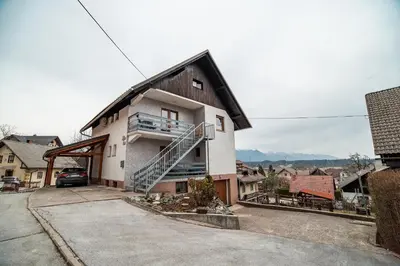 a house with a staircase on the side of it at Apartment Carmen in Brezje