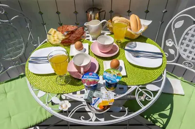 a table with a breakfast of eggs and toast at Čarman House in Bled