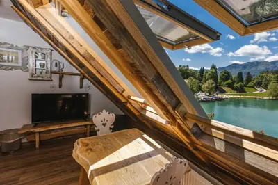 a living room with a view of a lake at Čarman House in Bled