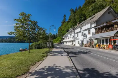 a street in a town next to a lake at Čarman House in Bled