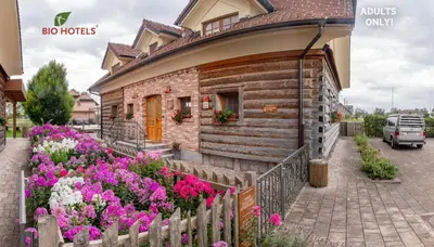 a building with flowers in front of it at Bio Apartments Trnulja in Ljubljana