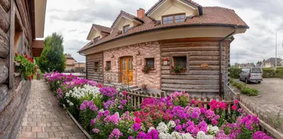 a house with flowers in front of it at Bio Apartments Trnulja in Ljubljana