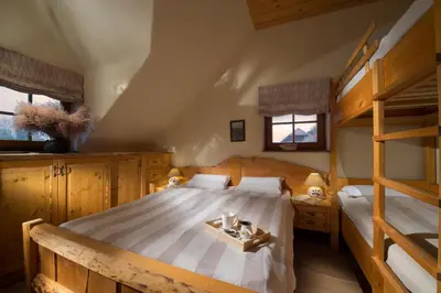 a bedroom with a bed and bunk beds at Bio Apartments Trnulja in Ljubljana