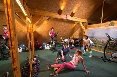 a group of people exercising in a gym at Bio Apartments Trnulja in Ljubljana