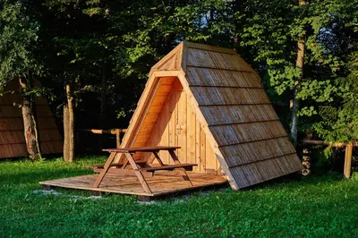 a small wooden play house in the grass at Glamping Village - Speleo Camp in Logatec