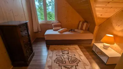 a small bedroom with a bed in a attic at Holiday Home- Mountain Lodge Gorjuše Pokljuka Bohinj in Koprivnik v Bohinju