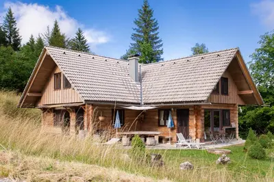a log cabin with a gambrel roof at Holiday Home- Mountain Lodge Gorjuše Pokljuka Bohinj in Koprivnik v Bohinju