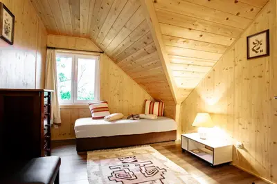a small bedroom with a bed in a attic at Holiday Home- Mountain Lodge Gorjuše Pokljuka Bohinj in Koprivnik v Bohinju