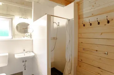 a white bathroom with a shower and a sink at Holiday Home- Mountain Lodge Gorjuše Pokljuka Bohinj in Koprivnik v Bohinju