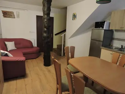 a living room with a table and a couch at Apartments Gubanec in Cerklje na Gorenjskem