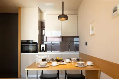 a kitchen with a wooden table with chairs at Apartmaji Guerila in Ajdovščina
