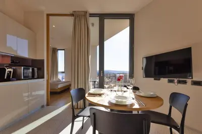 a kitchen and dining room with a table and chairs at Apartmaji Guerila in Ajdovščina