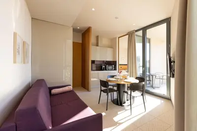 a living room with a purple couch and a table at Apartmaji Guerila in Ajdovščina