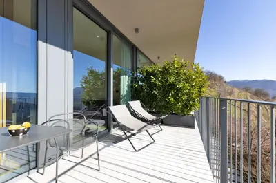 a balcony with a table and chairs on a building at Apartmaji Guerila in Ajdovščina