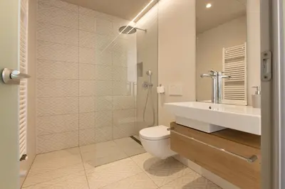 a bathroom with a toilet and a sink and a shower at Apartmaji Guerila in Ajdovščina
