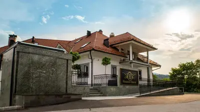 a white house with a red roof at Houston Resort in Radovljica