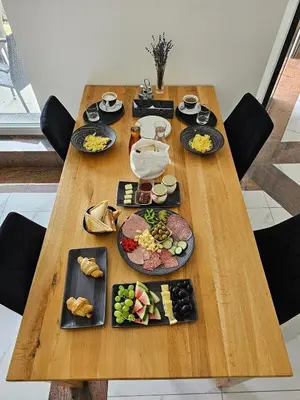 a wooden table with plates of food on it at Houston Resort in Radovljica