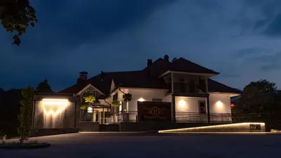 a house lit up at night with lights at Houston Resort in Radovljica
