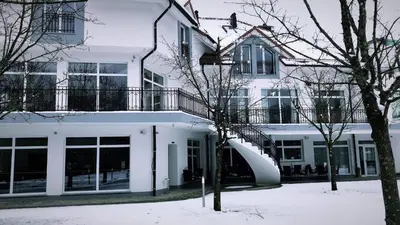 a white building with a slide in front of it at Houston Resort in Radovljica