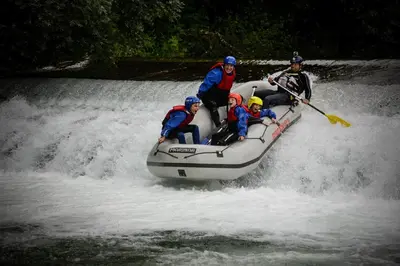 a group of people on a raft in a river at Forest Camping Mozirje in Mozirje