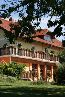 a building with a balcony with flowers on it at Panorama B&B in Ptuj