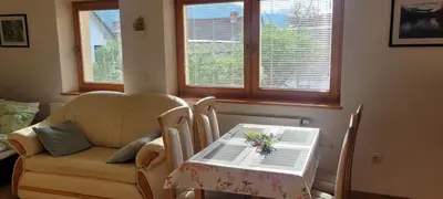 a living room with a table and a chair at Apartment Jalps 1 in beautiful Bohinjska Bistrica in Bohinj