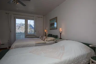a bedroom with two beds and a window at B&B Pletna a Double Lake-View Room in Bled