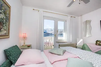a bedroom with two beds and a window at B&B Pletna a Double Lake-View Room in Bled