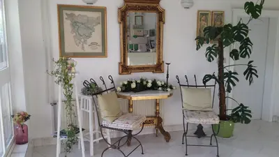 a room with a table and two chairs and a mirror at B&B Pletna a Double Lake-View Room in Bled