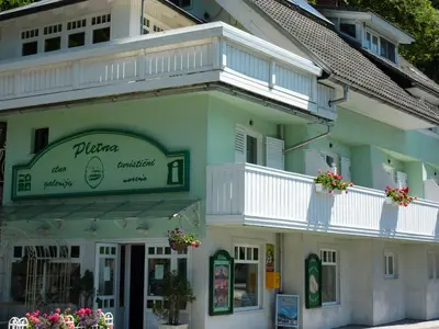 a building with a balcony on the side of it at B&B Pletna a Double Lake-View Room in Bled