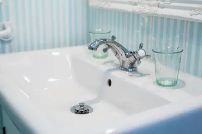 a bathroom sink with a glass sitting on it at B&B Pletna a Double Lake-View Room in Bled