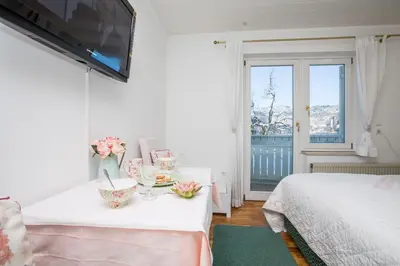 a bedroom with two beds and a tv on the wall at B&B Pletna a Double Lake-View Room in Bled