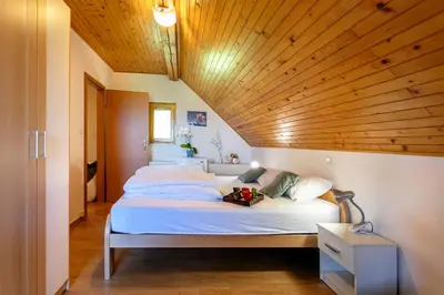 a bedroom with a large bed with a wooden ceiling at Quiet family house Butterfly place in Dob
