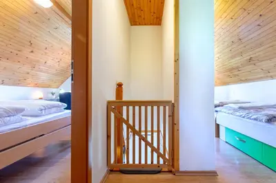 a staircase leading to a bedroom with two beds at Quiet family house Butterfly place in Dob