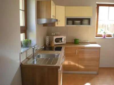 a kitchen with a sink and a microwave at Tourist Farm Rajšp in Benedikt v Slovenskih Goricah